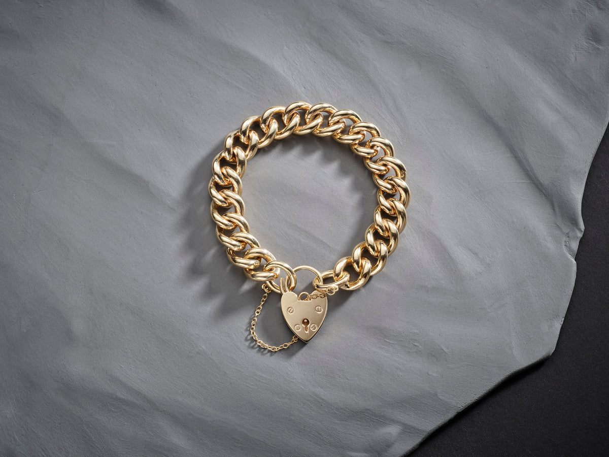 9ct gold curb chain bracelet with heart shaped padlock and safety chain