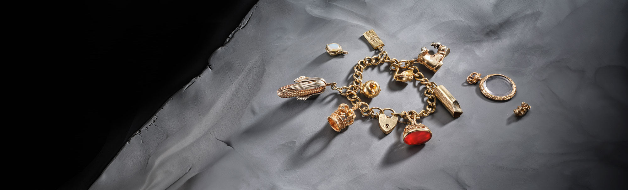 Inherited gold charm bracelet featuring koala, whistle , corn and boot charms.